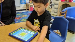 06 - Central Davie Preschool student Alan Reyes works with Cognitive ToyBox