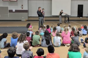 Camp Director, Jeremy Brooks, used first-grader, Noah Penland, as a ventriloquist puppet to explain what to wear at water day.