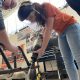 Automotive Instructor Seth James overseas War Eagle Motorsports member Laura Newsom in removing excess parts of the frame during early fabrication