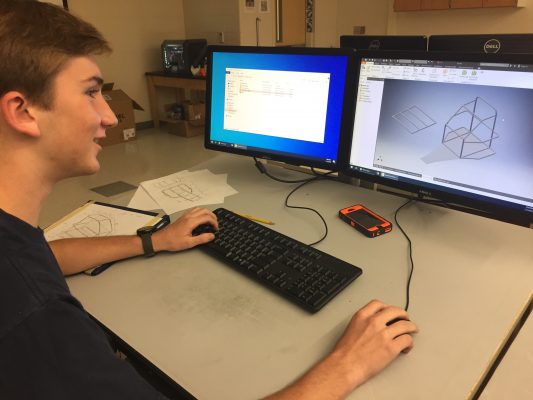 Jackson Clark, a War Eagle Motorsports member and leader of the "Zip-Ties" engineering group, works on a digital model of the vehicle.