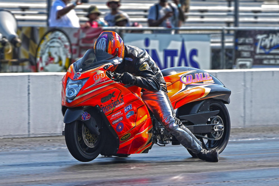 Team rider Jason Dunigan just took a win in Pro Street while in competition with XDA at Maryland International Raceway. Photo of DME custom orange motorcycle winning the race.  
