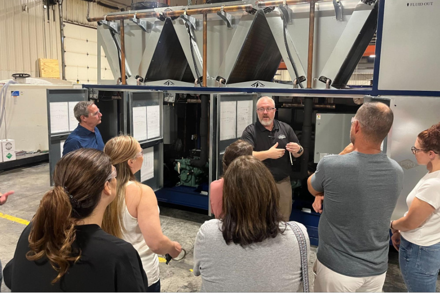 ( L to R)  Gene Kneeland, Amy Hardister, Dianne Ireland, Hannah Beck, Lisa Doss, Joey Anderson, and Chelsea Dvorak look on as Damon Reed explains a chiller system during the group’s visit to Pro Refrigeration. 