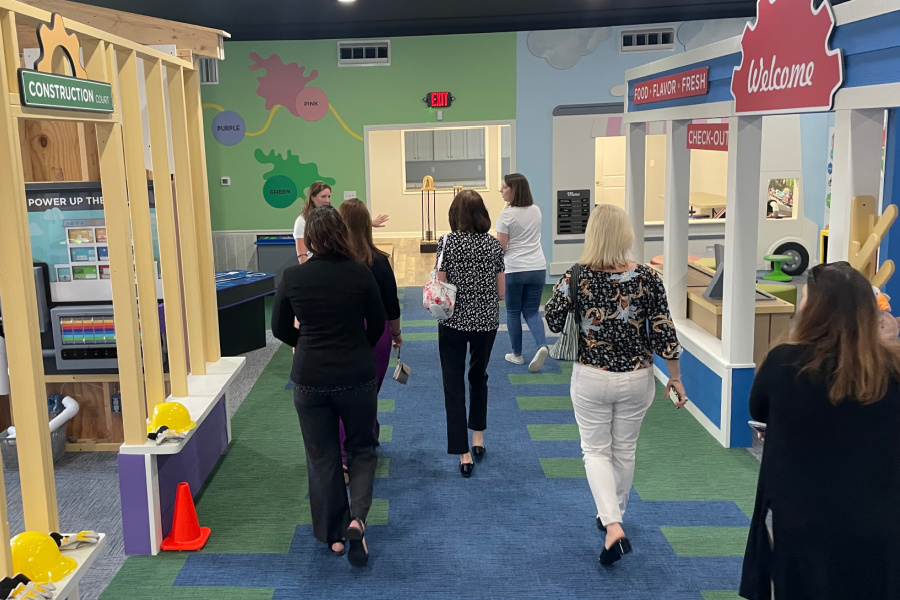 Ribbon-cutting attendees tour COGNITION’s interactive space for children