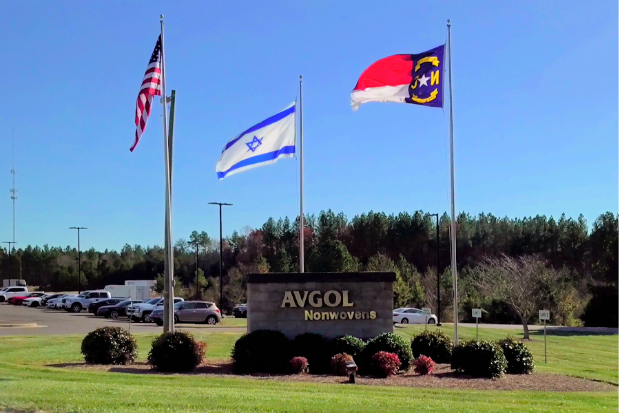 Global manufacturer Avgol's Mocksville Facility sign and flags. 