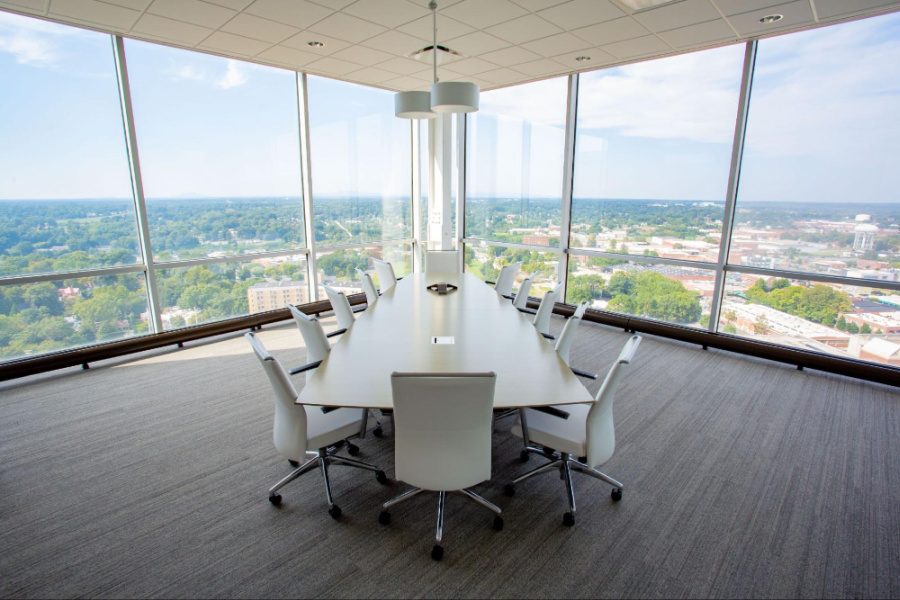 An empty conference room located on the upper level of a skyscraper, where Flow Automotive Companies is headquartered, overlooking downtown Winston Salem, NC
